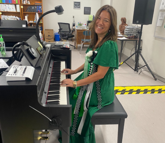 Principal Stacie Humbles takes a few moments out of the busy Homecoming day to play the piano.